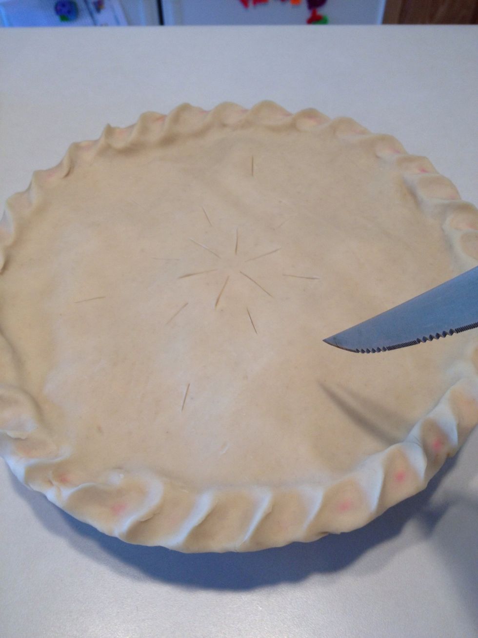 After crimping your edges, you need to cut air pockets in the crust. I like to make simple designs with straight lines.