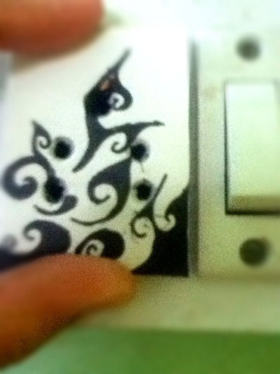 After cutting out the holes, place it on the plug to make sure it is in the exact same place.. Make sure that the light switch is off.. We don't want anyone getting an electric shock..