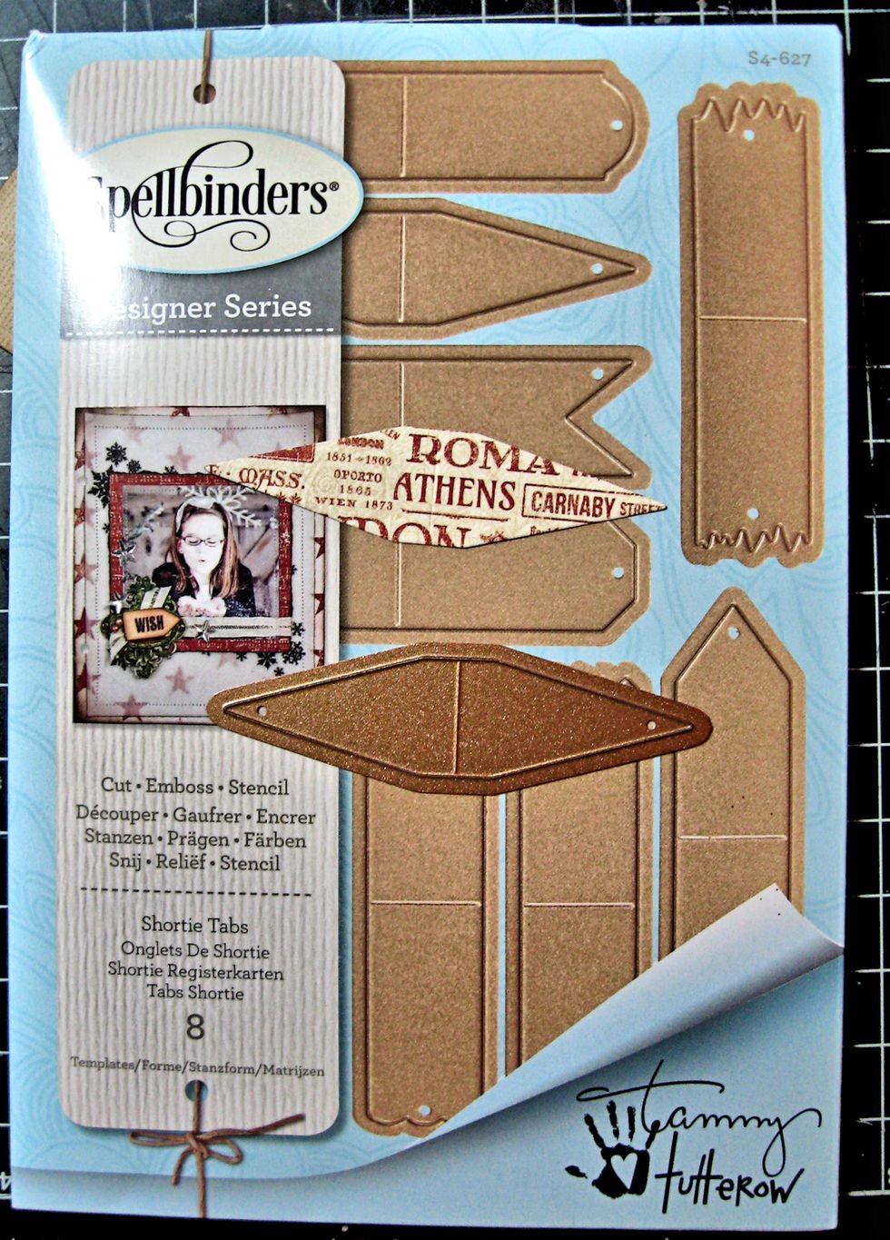 After cutting out the mini postcard, use the Shortie Tabs die and cut another piece of patterned paper. It is pre-scored in the center. Ink the edges and crease.