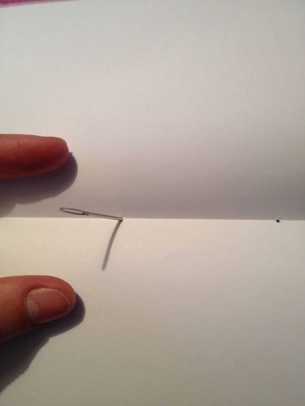 After cutting the slits in the paper take your thick needle (TN) and just push it thru the slits to make them little holes just makes the stitching process easier. Push from then inside out.