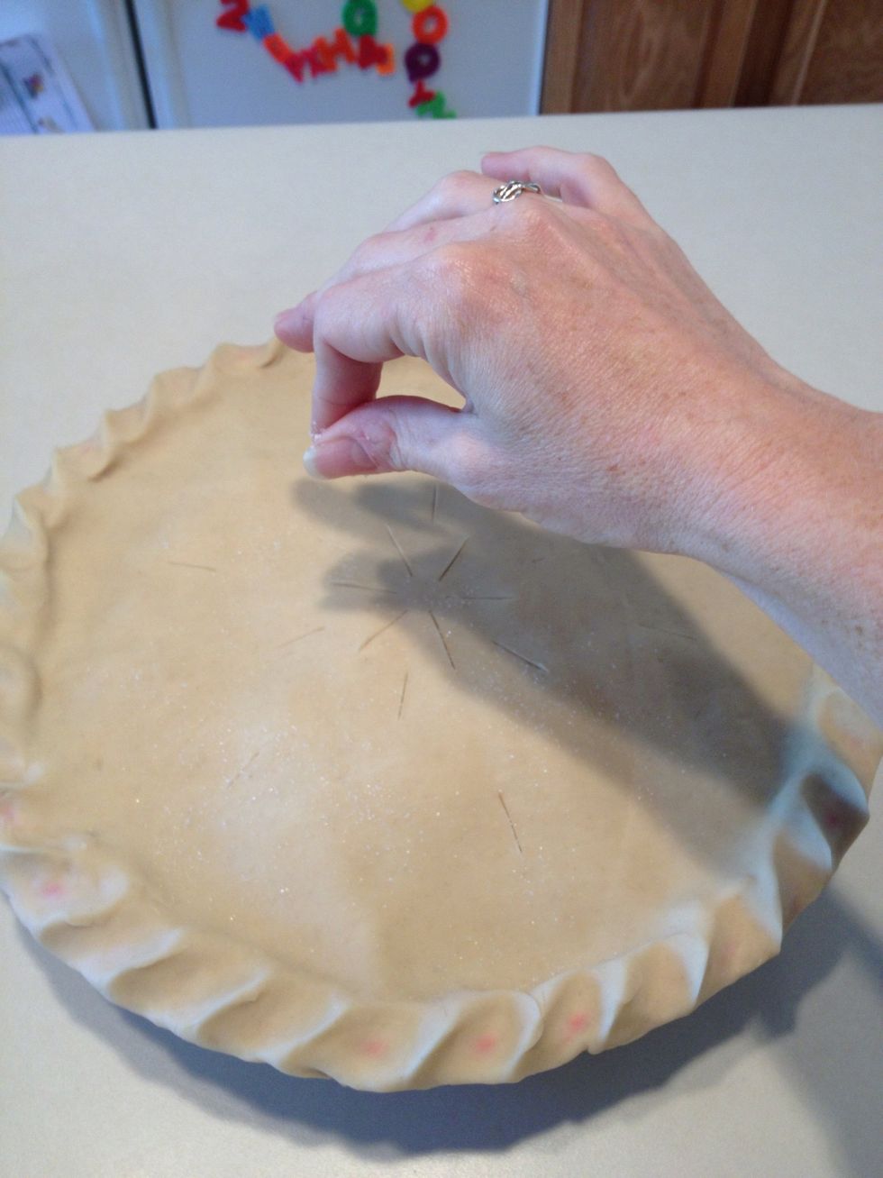 After cutting with a knife, sprinkle the top with sugar. This makes the crust sparkle when you've finished baking!