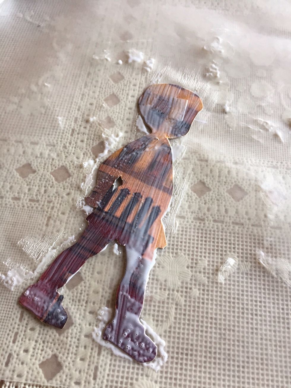 After deciding where you want to put pictures on globe, working on waxed paper, spread Modge Podge on back of picture....