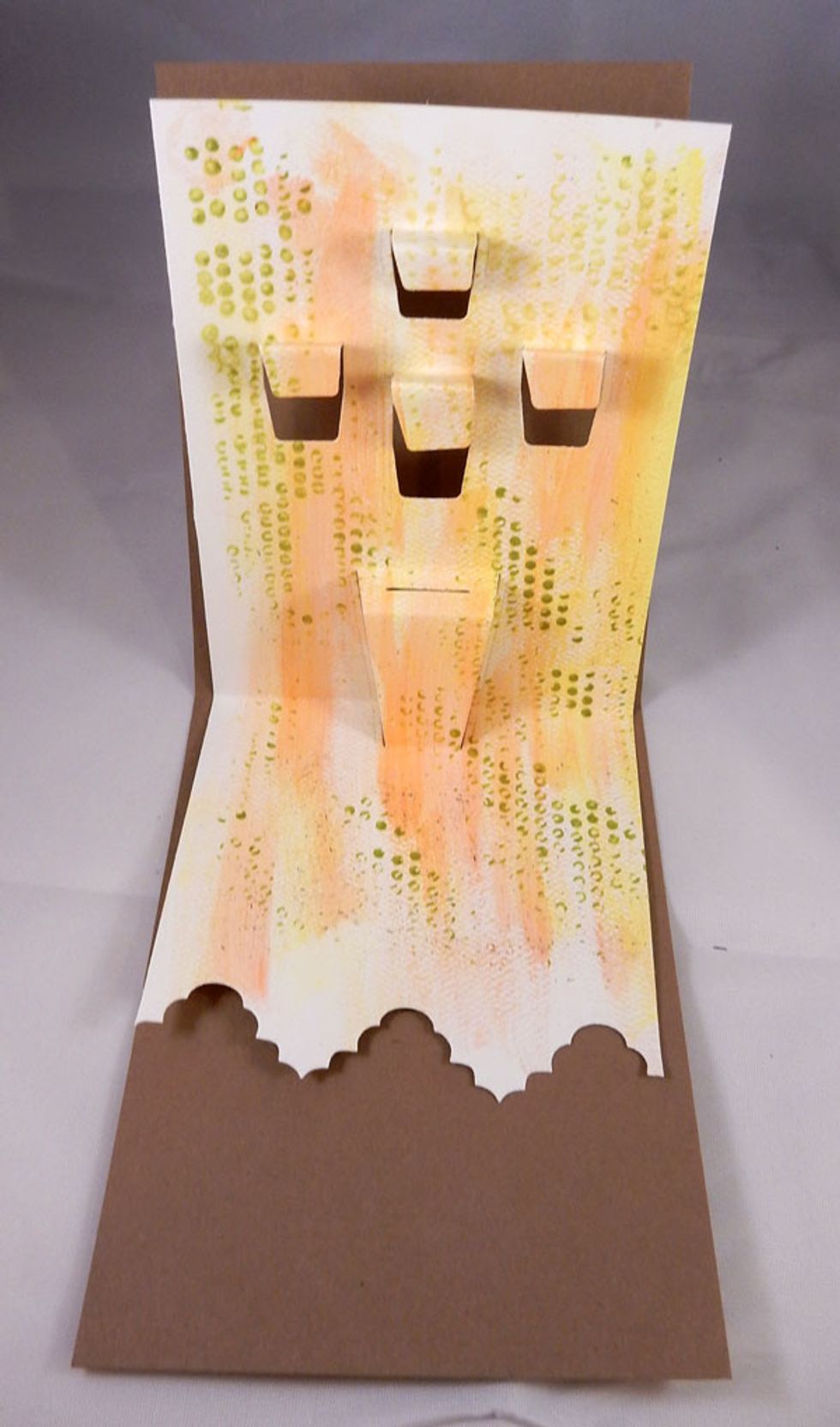 After die cutting,  the panel will look like this - fold on the scored lines to create the tabs onto which we will add all the elements.  Ink the edges of the panel with brown ink.