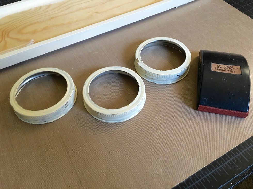 After distressing with a sanding block, your mason jar lid "rings" should look something like this.