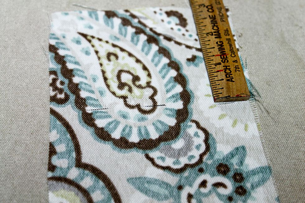 After doing so you will be left with 3" that one of the ends needs to be shortened.  This shortened end piece will be stitched to the zipper pull end of the zipper.