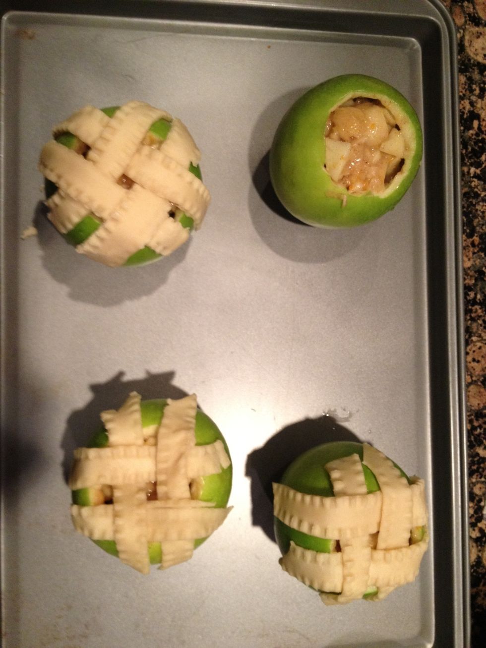 After filling apples to the top with filling-mixture, weave dough strips in basket pattern onto top of apple and dropping over the sides.