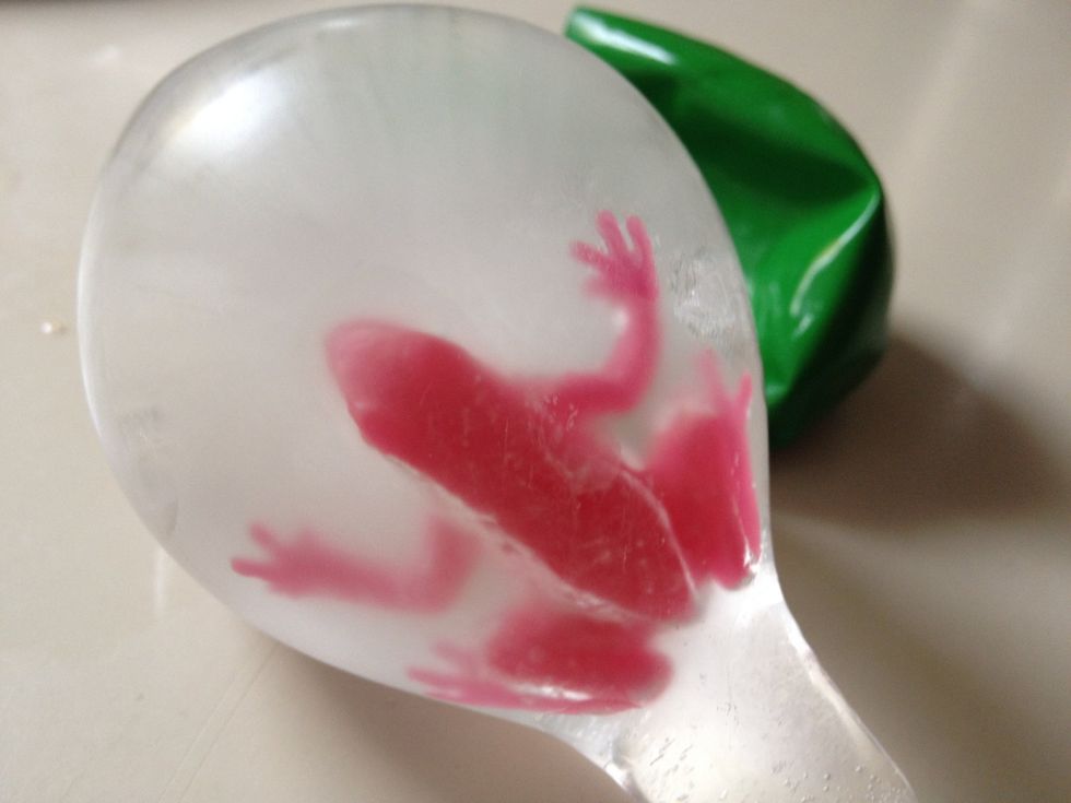 After freezing over night, take the balloons out of the freezer and cut away the balloon. If you cut off the top of the balloon, it peels away nicely to reveal the frozen egg!