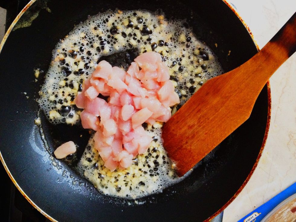 After garlic becomes gold add chicken pieces.