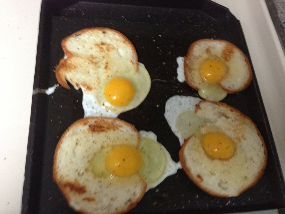 After grilling one side of bagel, flip them and then crack an egg in the hole .