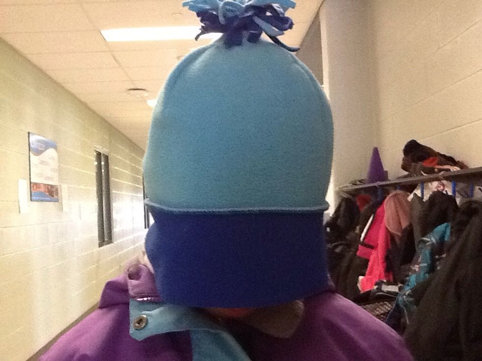 After, grip on your hat in your hands and place it on top of your head.