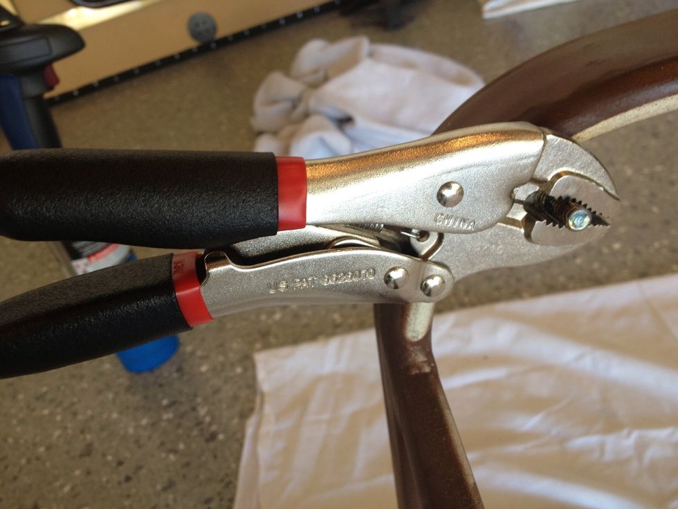 After heating the broken bolt until red hot then letting cool, we used the vice grips to get a good grip on it and work it loose.  Sometimes we would use a back and forth motion.
