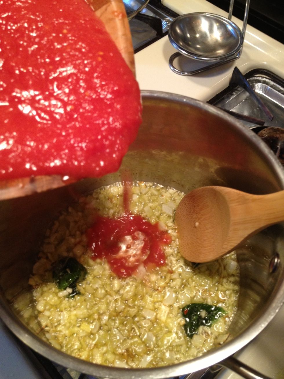 After I added the garlic I cooked it for 2-3 minutes stirring frequently with my spoon. I immediately added my tomatoes