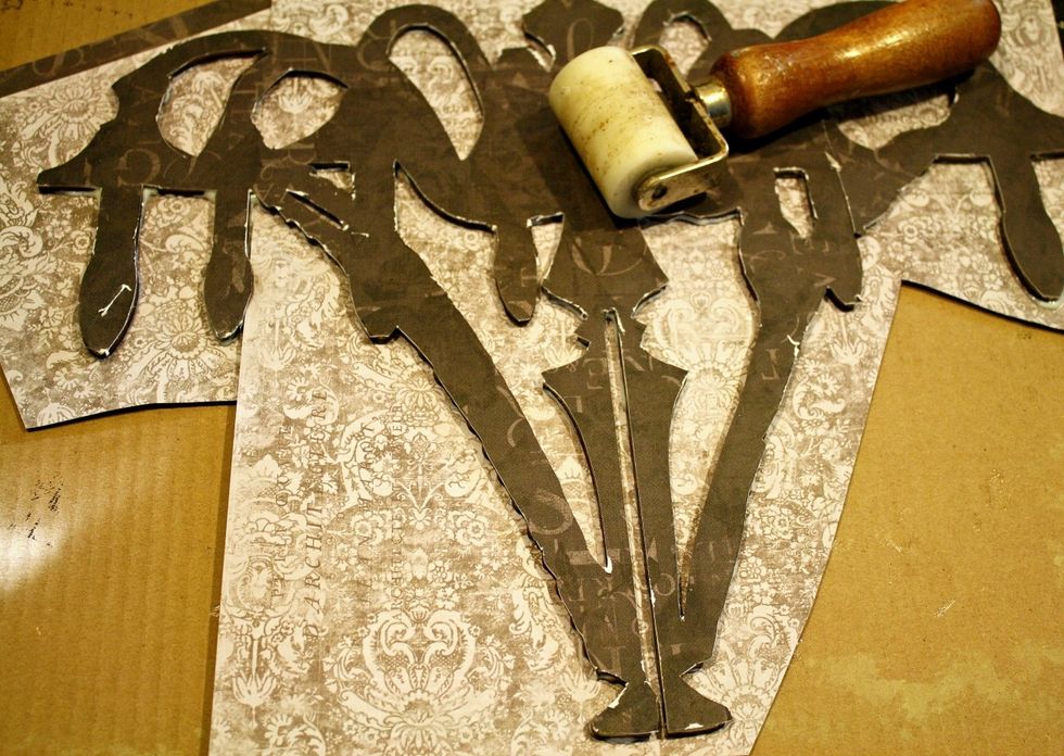 After I adhered paper to the backside , I used a brayer again to flatten my paper to my surface. I like to flip the chandelier over and roll the backside too.