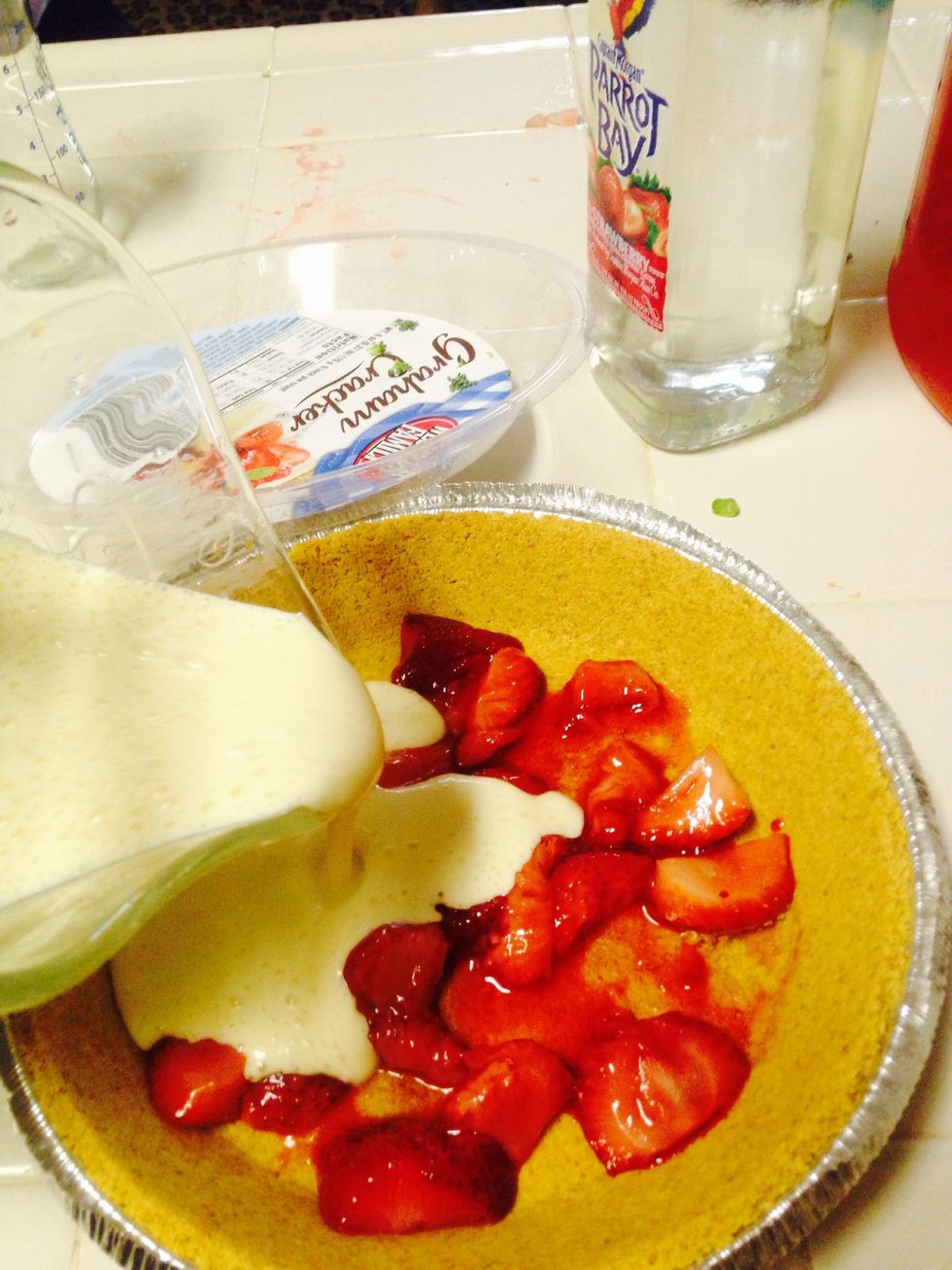 After I start pouring in my mixture, you can mix the strawberries around with the mixture after pouring it all in but I left mine alone