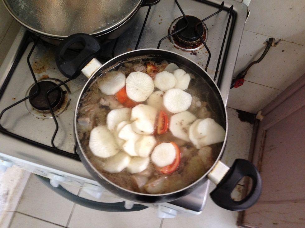 After it boils. Add tomatoes and radish. Boil for 5 minutes.