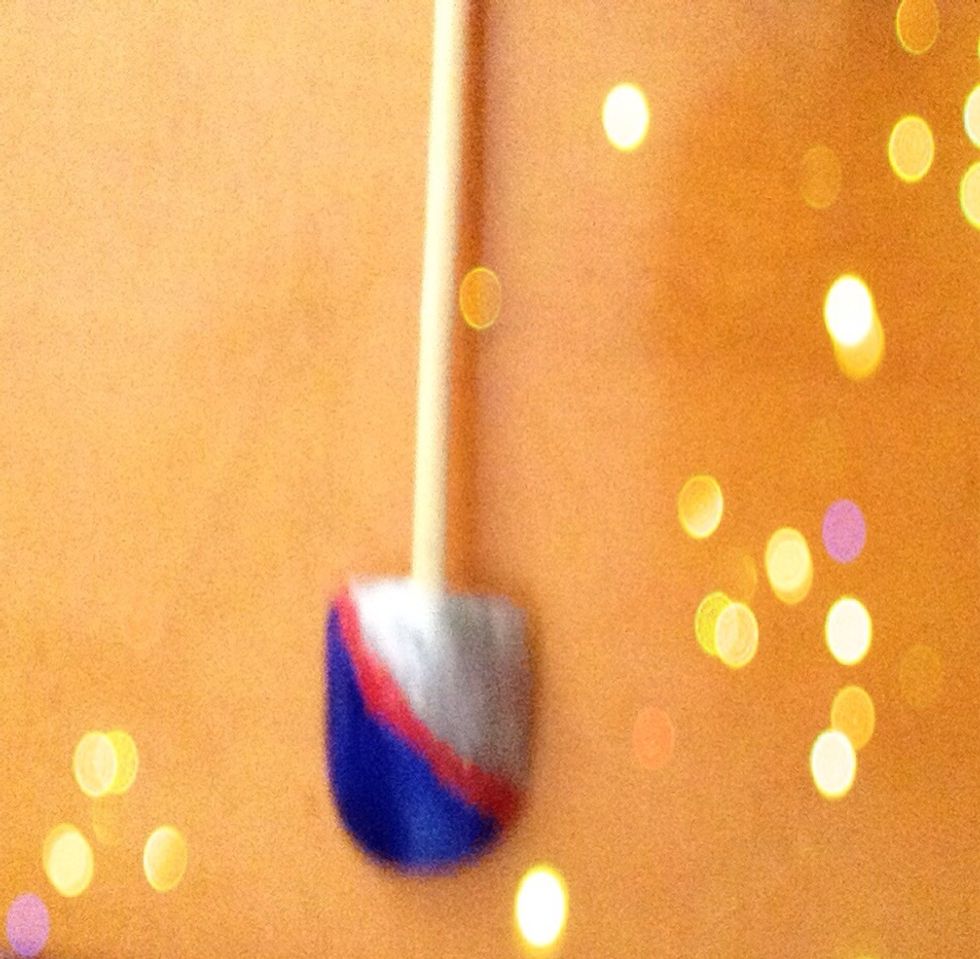 After it dries, paint one red stripe at the beginning of the silver ( white ) half.