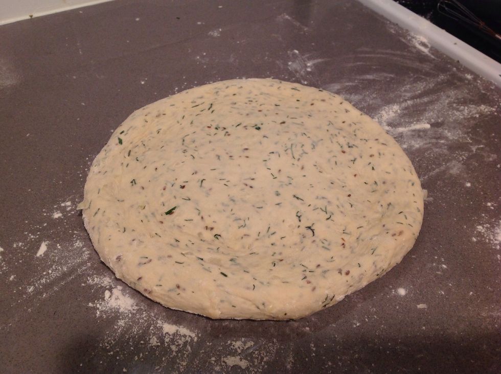 after it rises for the second time, push it back down and make a flat disk(push down gently...Don't flatten like you would with pizza dough).