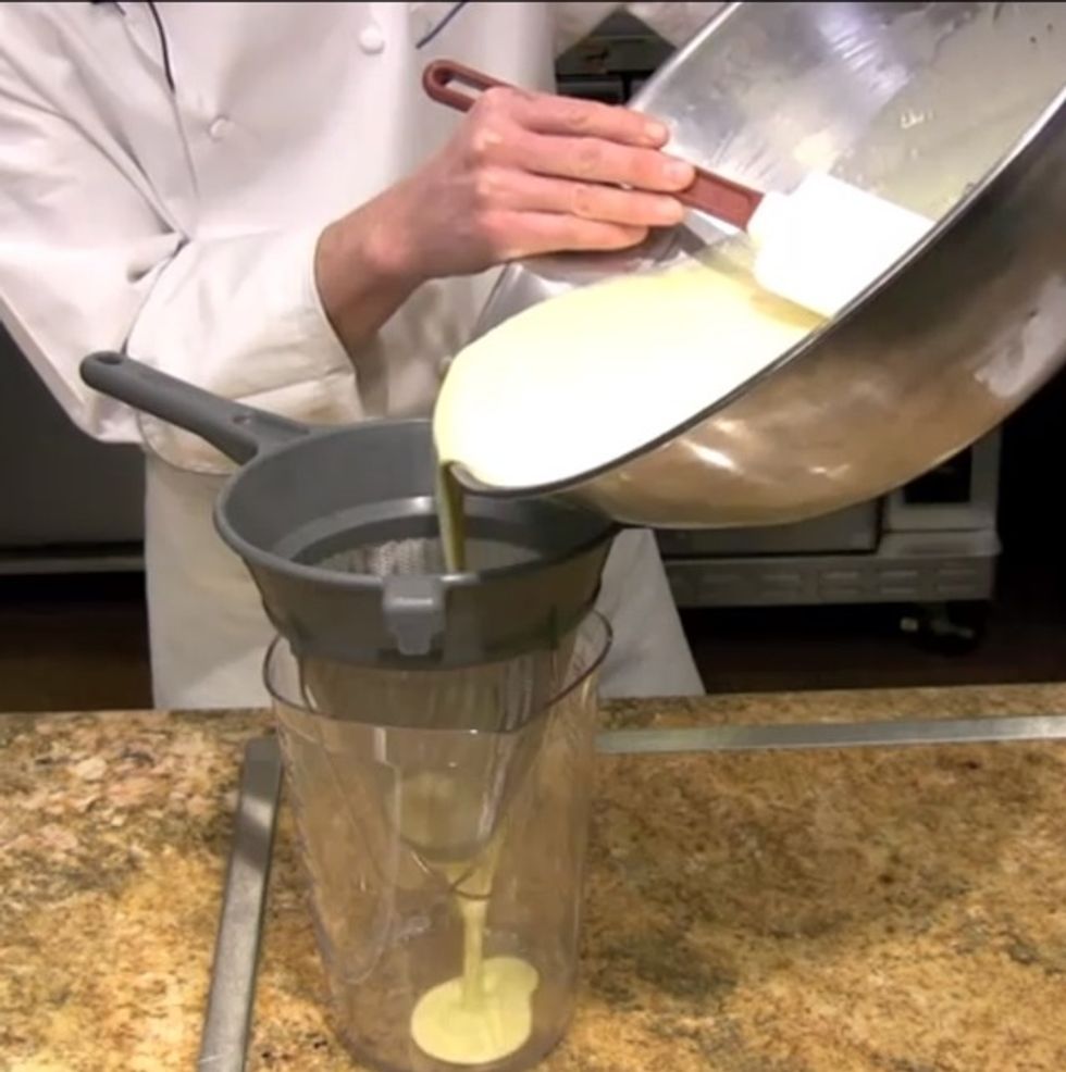 After letting your batter sit overnight, strain it into a pitcher.