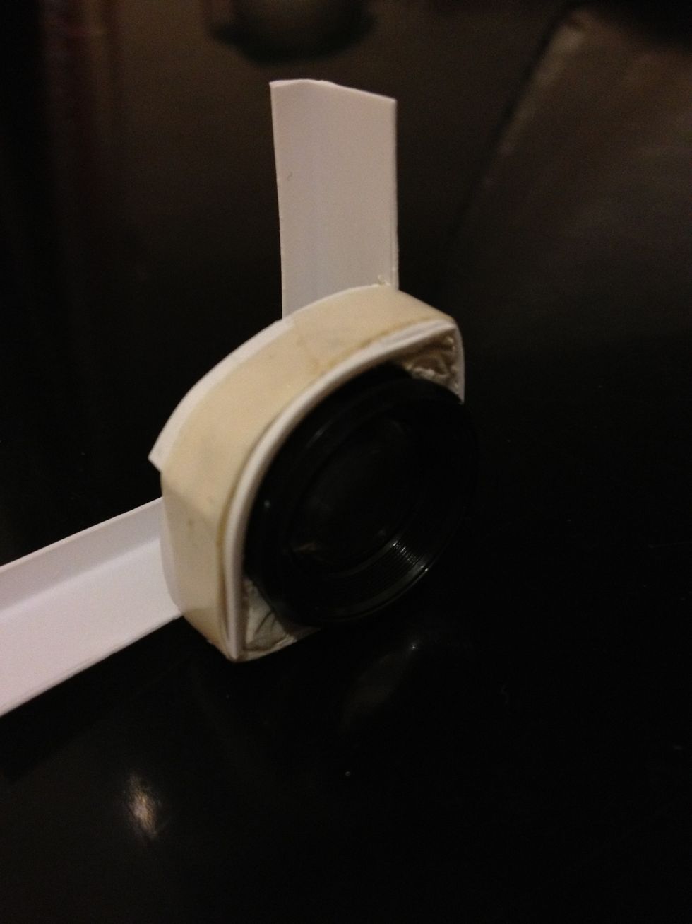 After making sure the lens are sitting at the right place, wrap the two ends around the lens with tape to secure its position. Tape type depends on holder material.