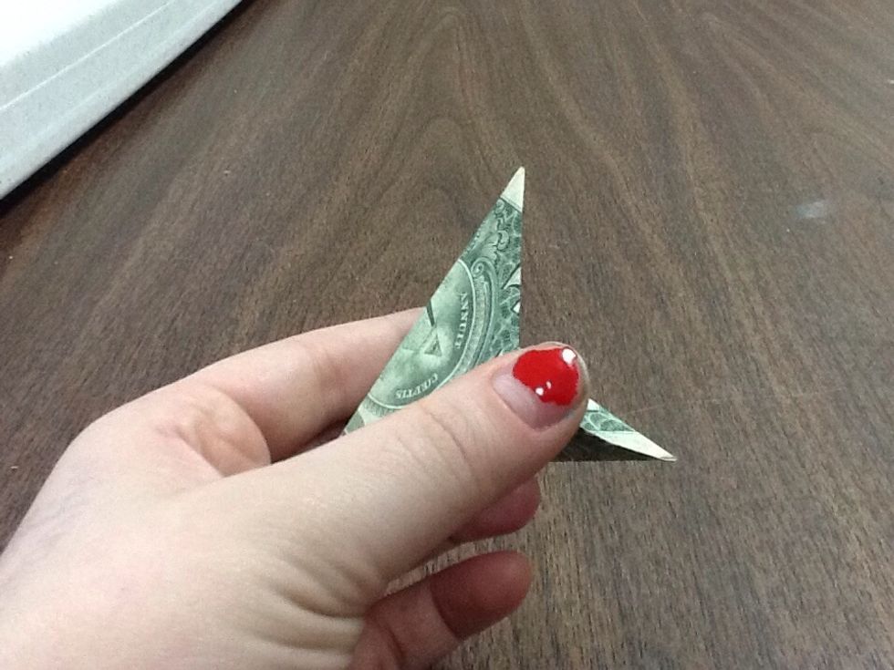 After making sure you've created sharp creases underneath, take your finger and stick it in the opening, while pushing the sides in with your other hand. It should gape open like this.