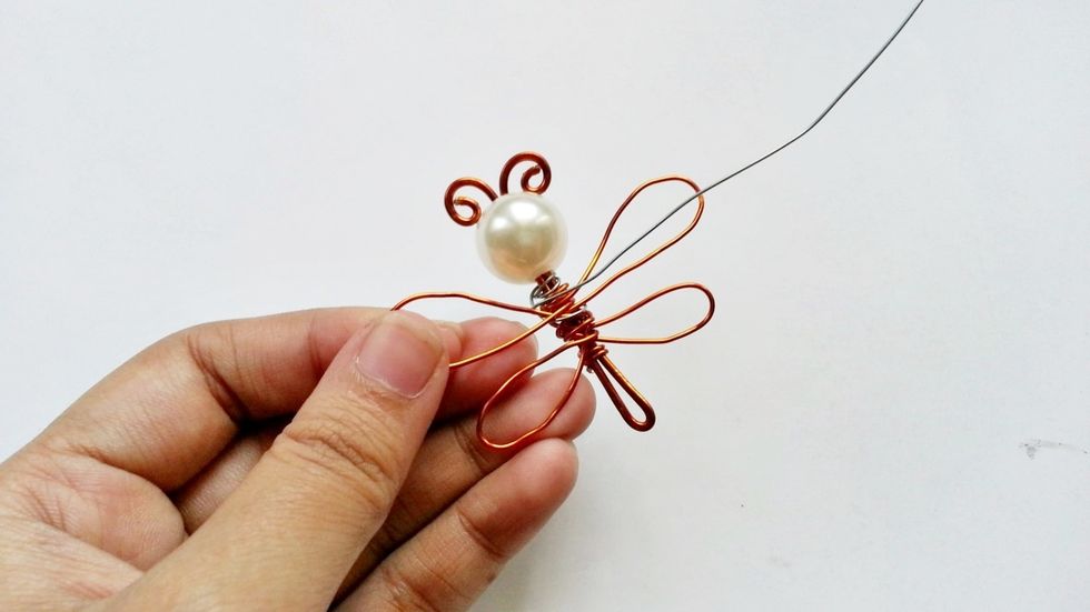 After making the wings, use a different colored wire (I used 22 gauge silver craft wire) to make another pattern inside the main wings.