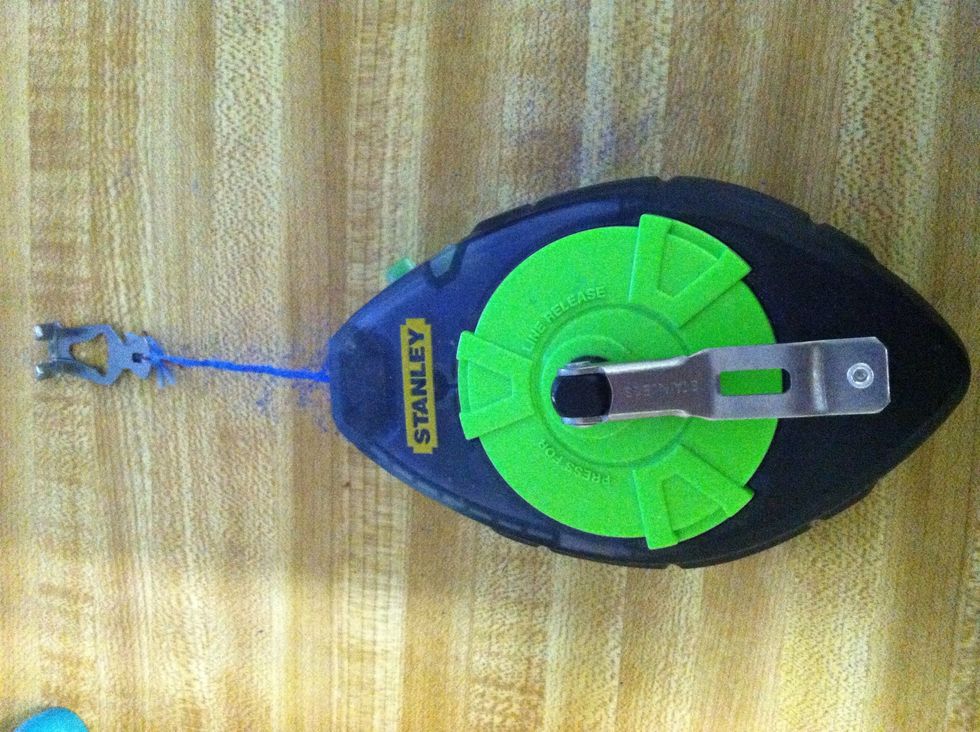 After measuring, I used a Blue Chalk Line Reel to ensure the lines were straight. Hold it on one side of the wall while someone else pulls it to the other side.