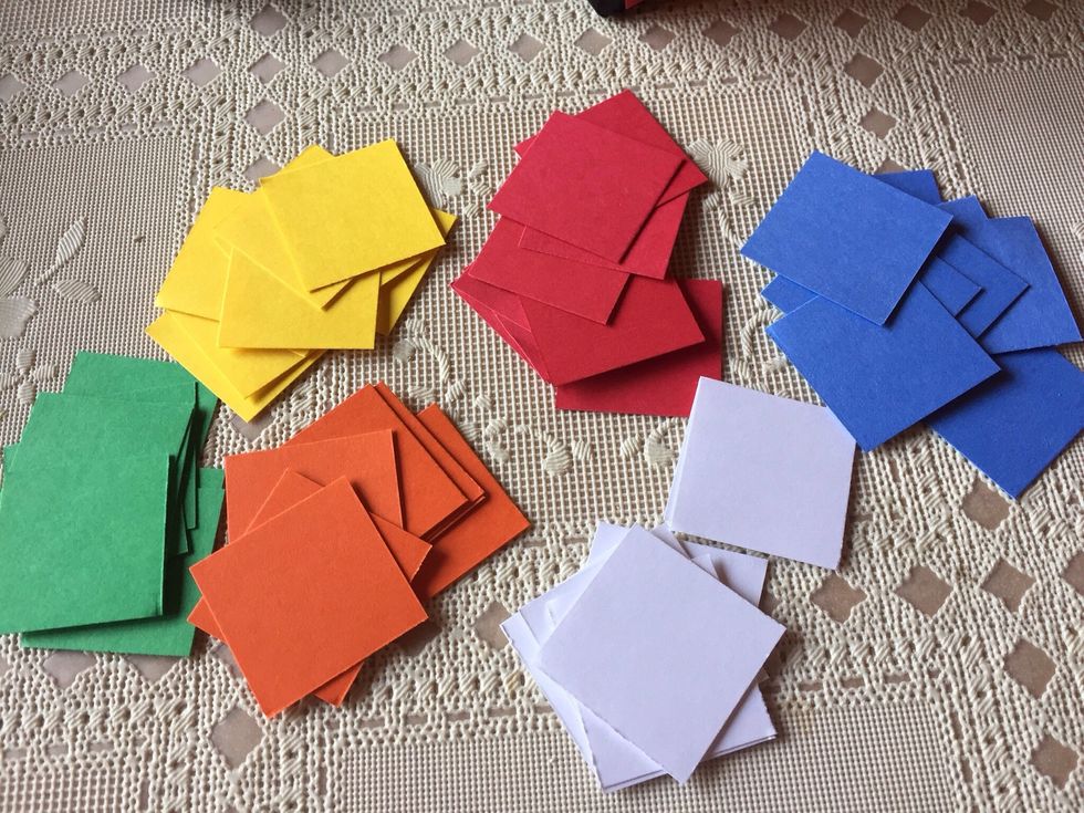 After measuring wrapped box, figure what size square will work, and cut 54 squares of the six different colors of card stock for each cube you are making.