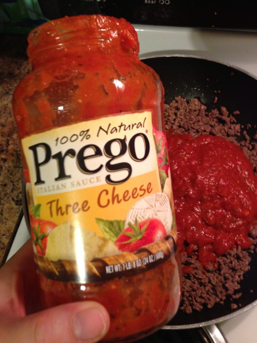 After meat is browned and cooked add pasta sauce to meat and stir. Turn heat down to a simmer. My meat was extra lean so it didn't need to be drained but you should drain yours first if its not.