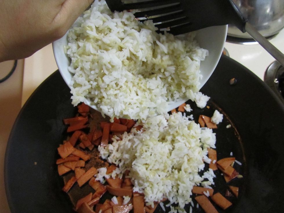 After meat is cooked, add rice and stir well.