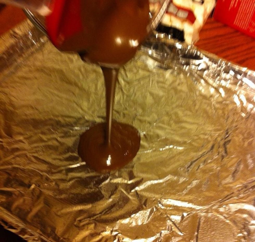 After melting the chocolate, pour one cup of it onto your pan and spread using a rubber spatula.