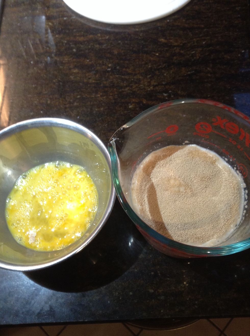 After milk yeast mixture has sat at least 10 minutes Lightly beat the one egg and whisk into the milk yeast mixture dissolving yeast in the process.