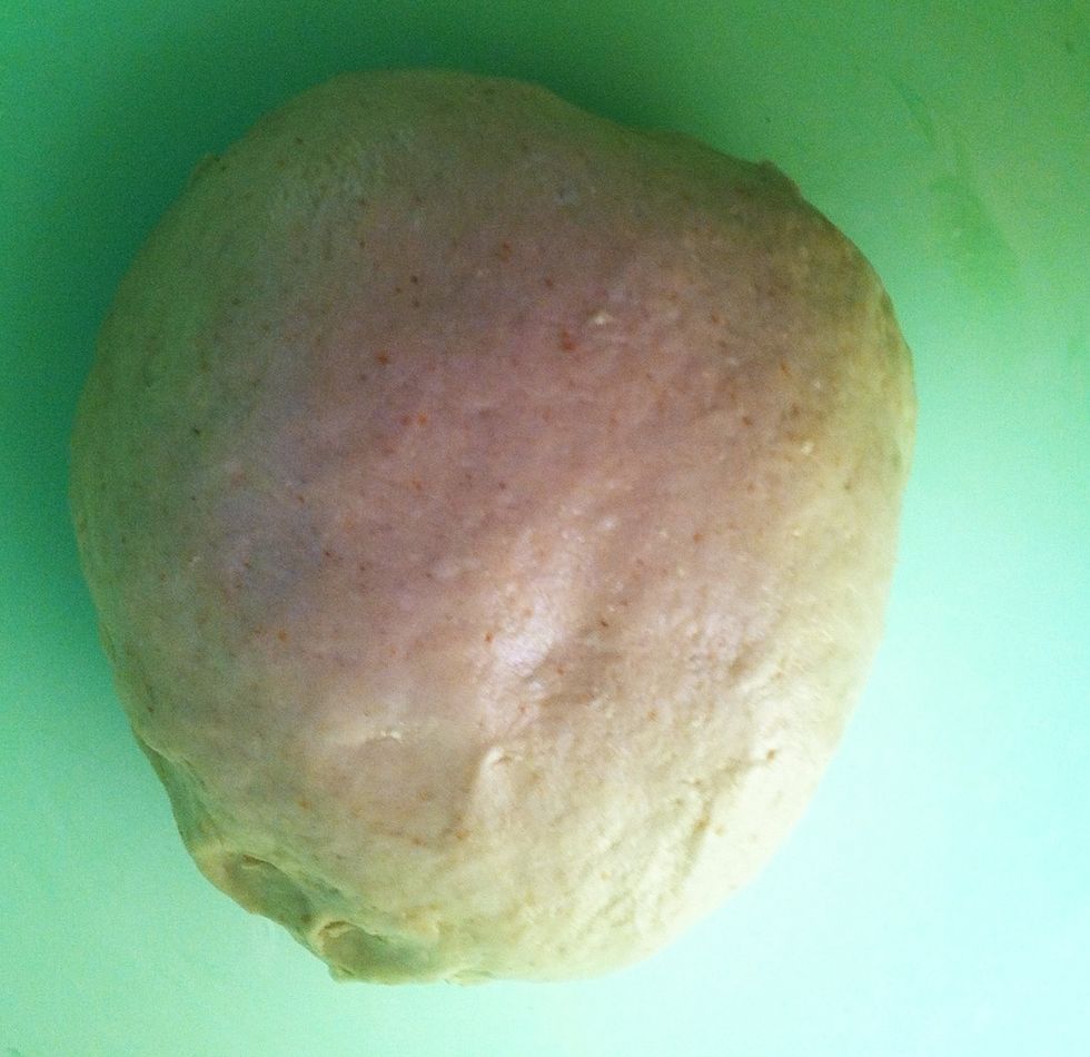 After mixing the ingredients, grease a bowl with butter, margarine, oil, or  baking spray.  Place the dough in it and turn it around so that the dough is also coated. Cover and leave in a warm place.