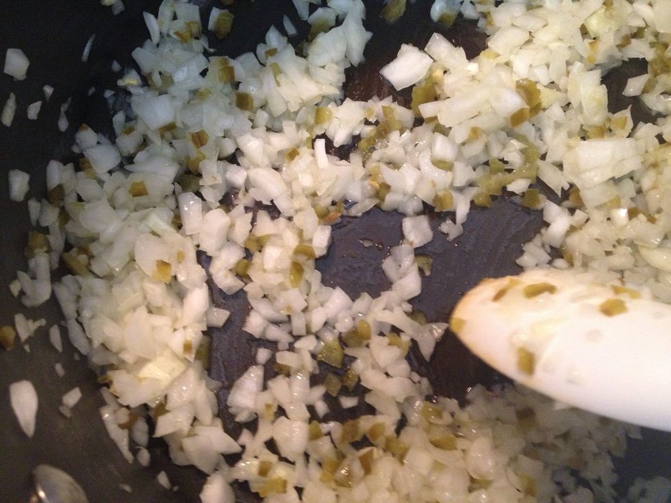 After oil is hot. Add the onion & jalape\u00f1o. Saut\u00e9 for a few minutes.