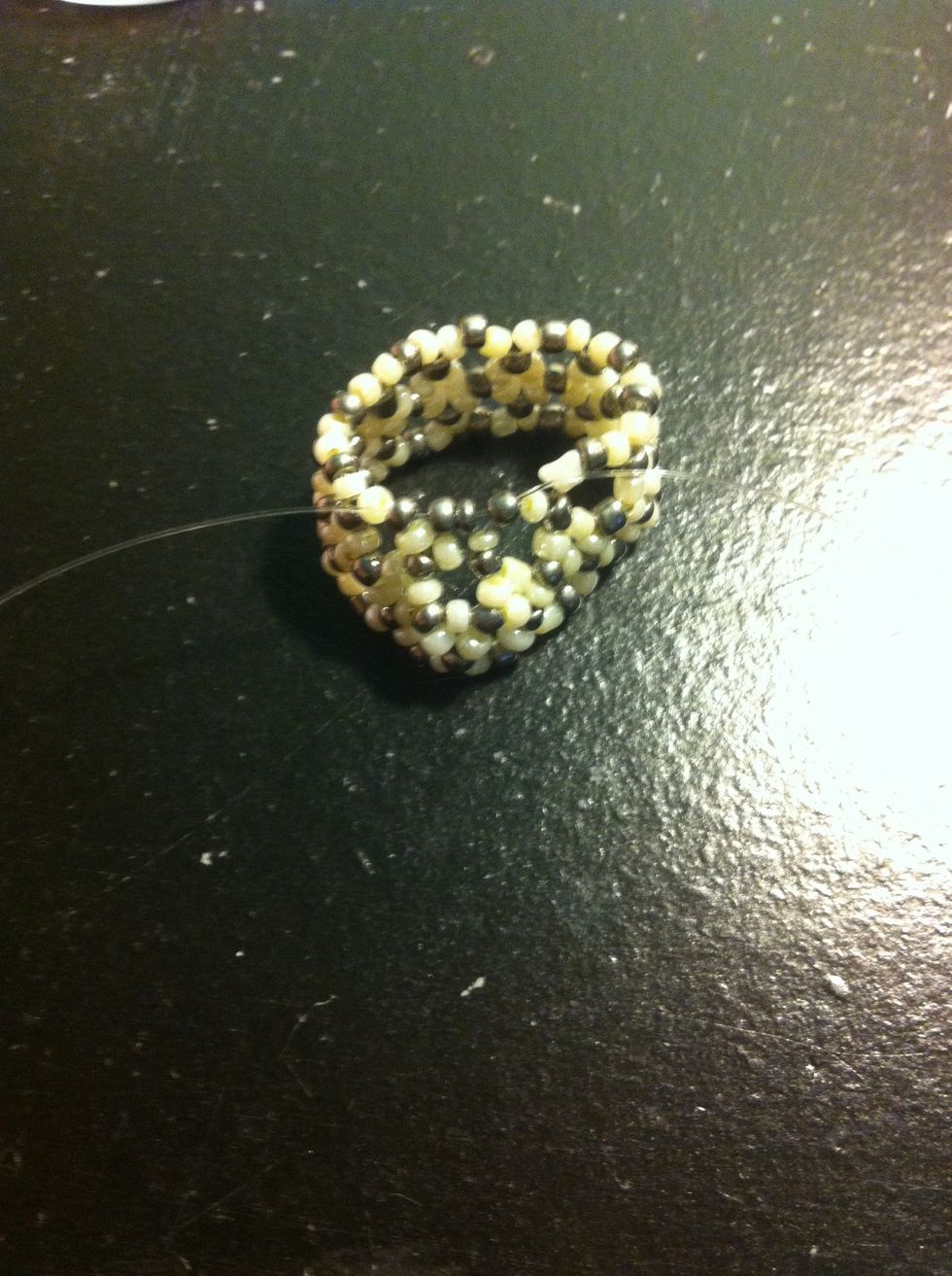 After, on the left string bead on 2 silver beads and string the cord through the next silver bead on the left