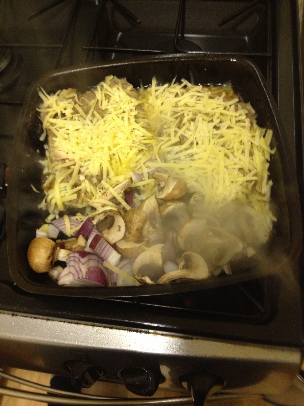 After one side is done turn it over add mushrooms onion to the pan and a good layer of cheese over steak.... Mmmm then put your baguette in the oven on a tray