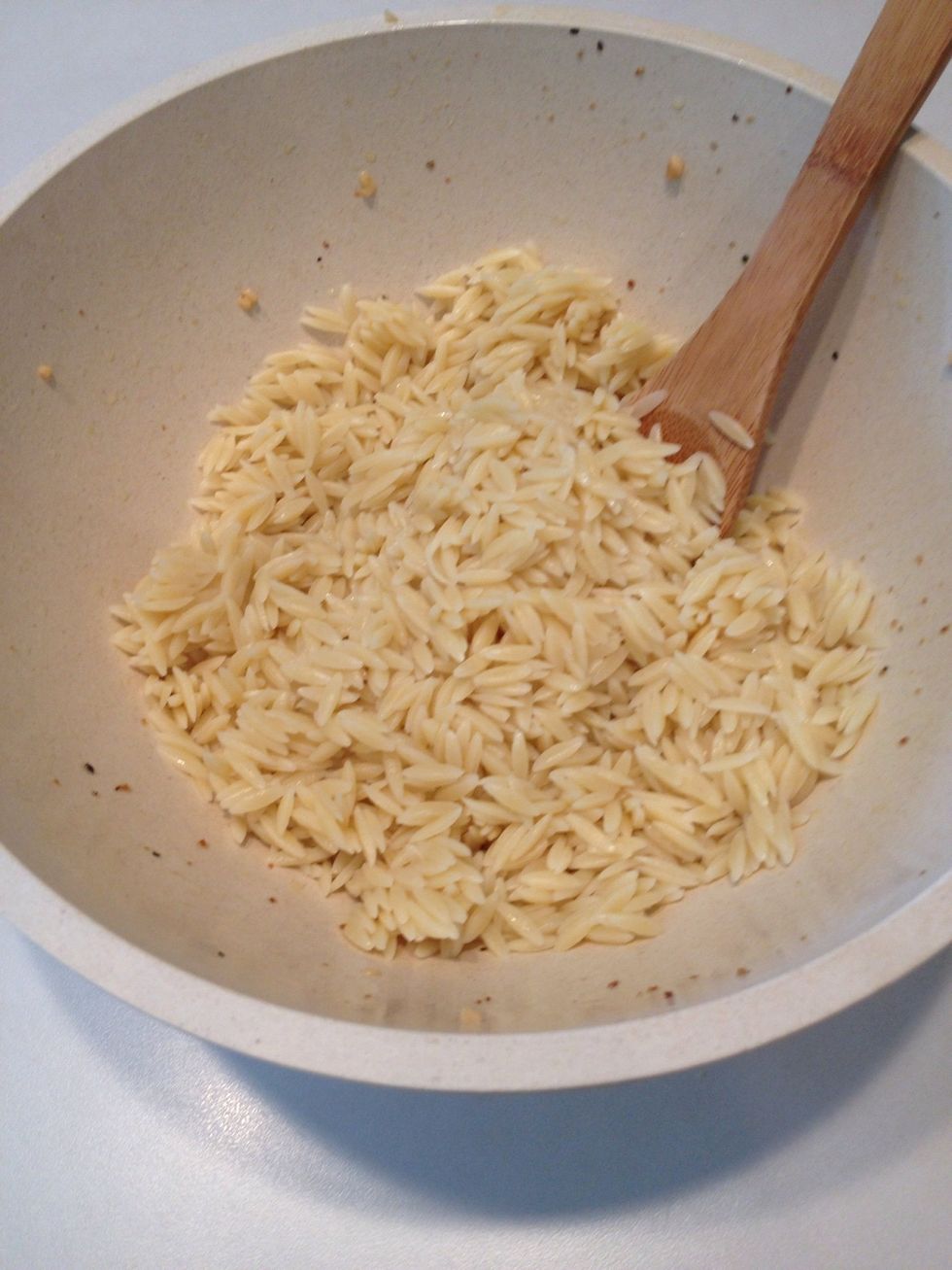 After orzo is cooked and drained, place in serving bowl.