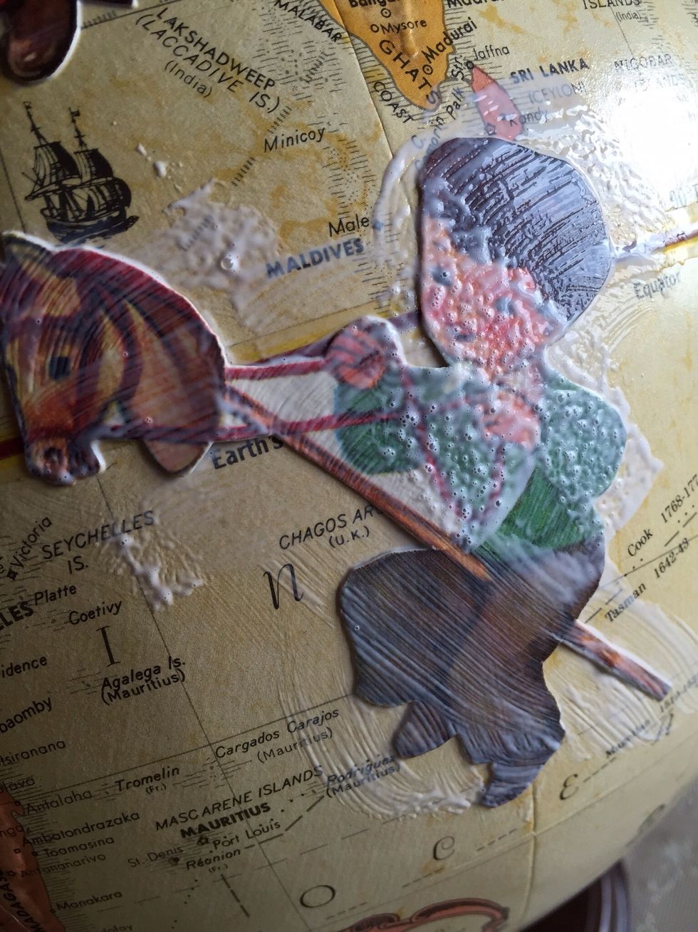 After picture is sealed on globe, spread Modge Podge over top of picture. Let dry and repeat with a second layer of Modge Podge.
