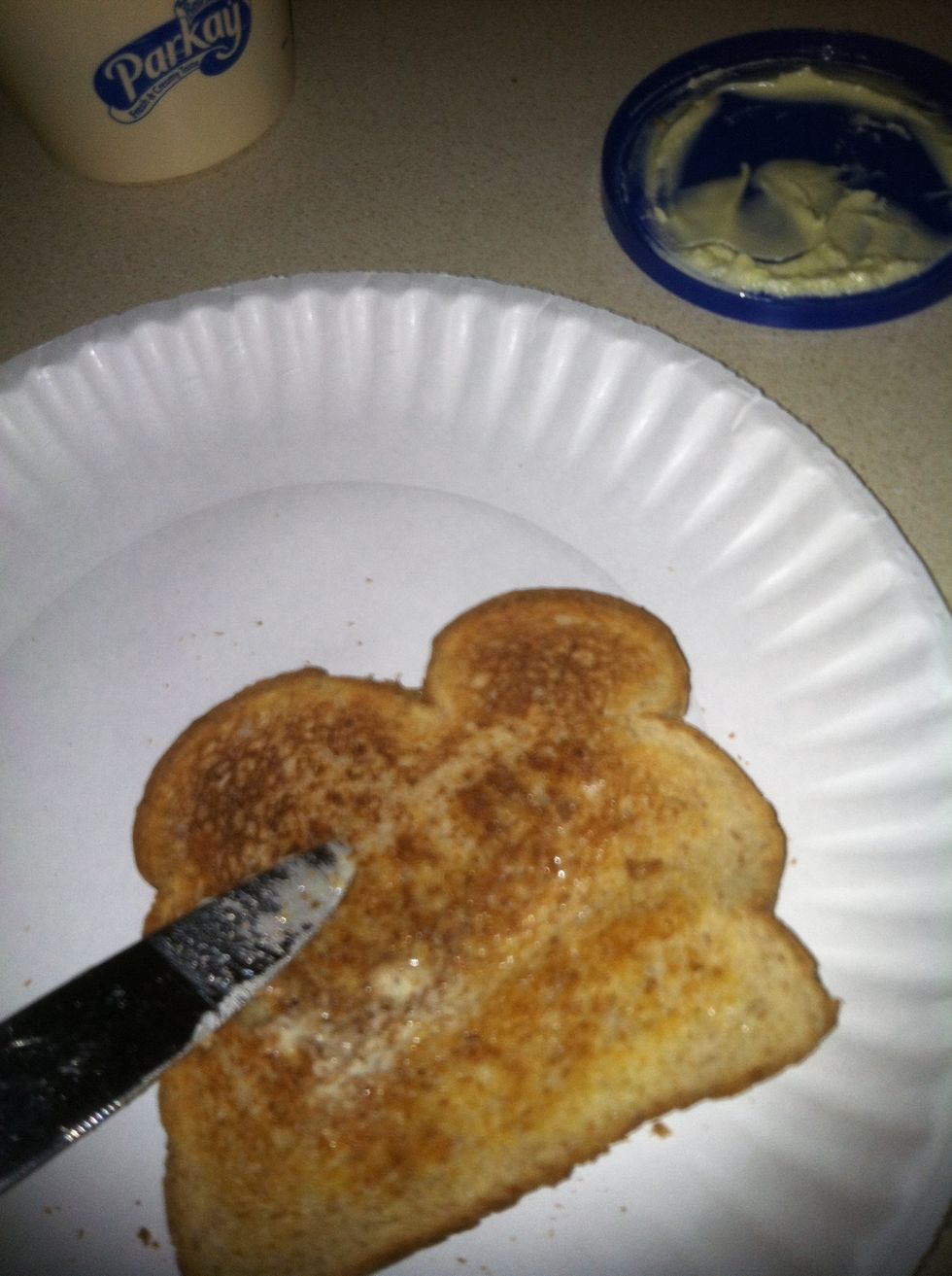 After, place the toast on the plate, then spread butter throughoutly