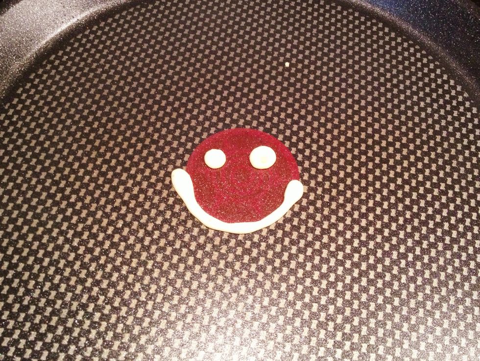After pouring your mix into a sauce container, heat a nonstick pan on low heat. Draw a happy face. Depending on how thick your mix is, you'll find thinner mix is a bit more challenging.