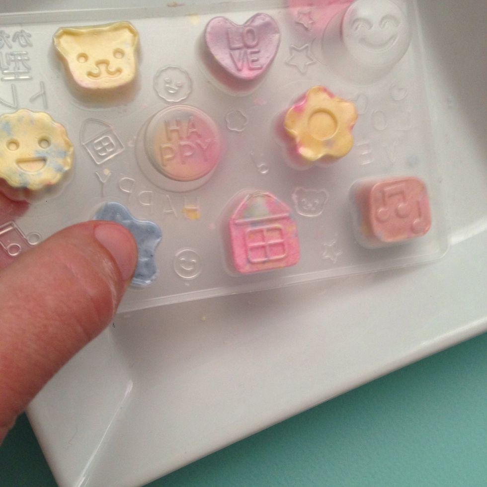 After pressing remove the top of the mold and press down to pop the candy out of mold