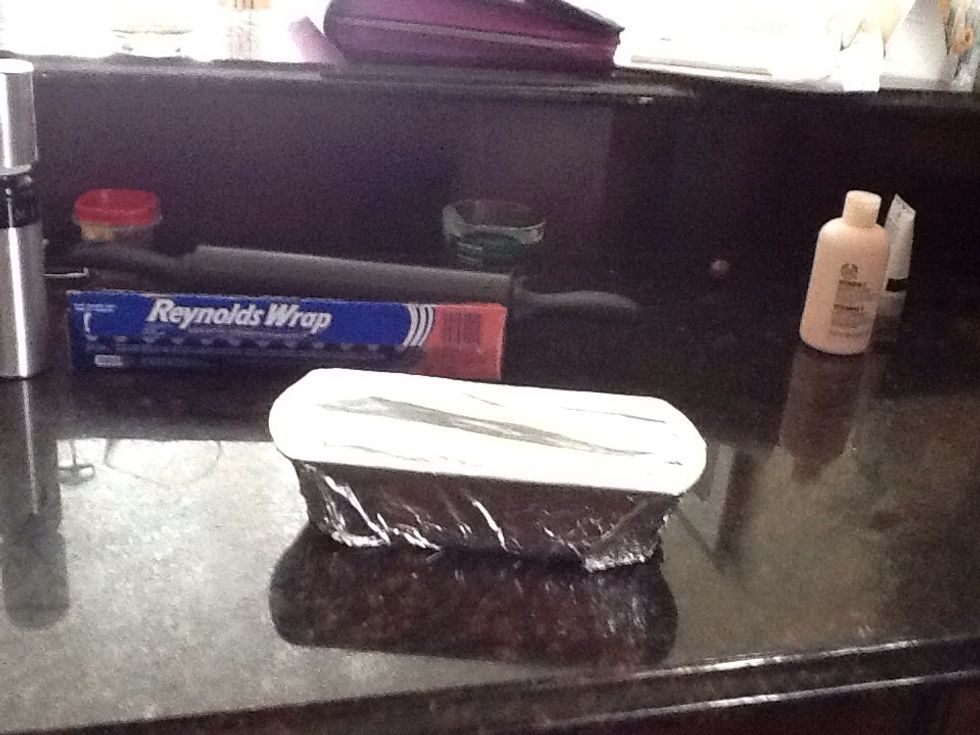 After punching down on the dough, put the dough in a bread pan and cover it with aluminum foil, let it rise for 10 minutes or just until it's doubled in size.