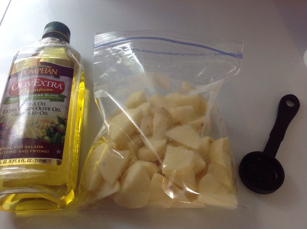 After, put the potatoes into a ziplock bag, then add 1 1/2 tablespoons of olive oil, or as much as you think you need.