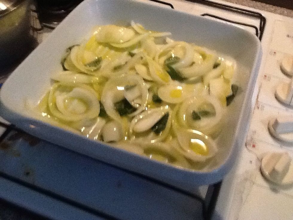 After putting the onion on the stove, add oil, sage, salt and pepper to it.