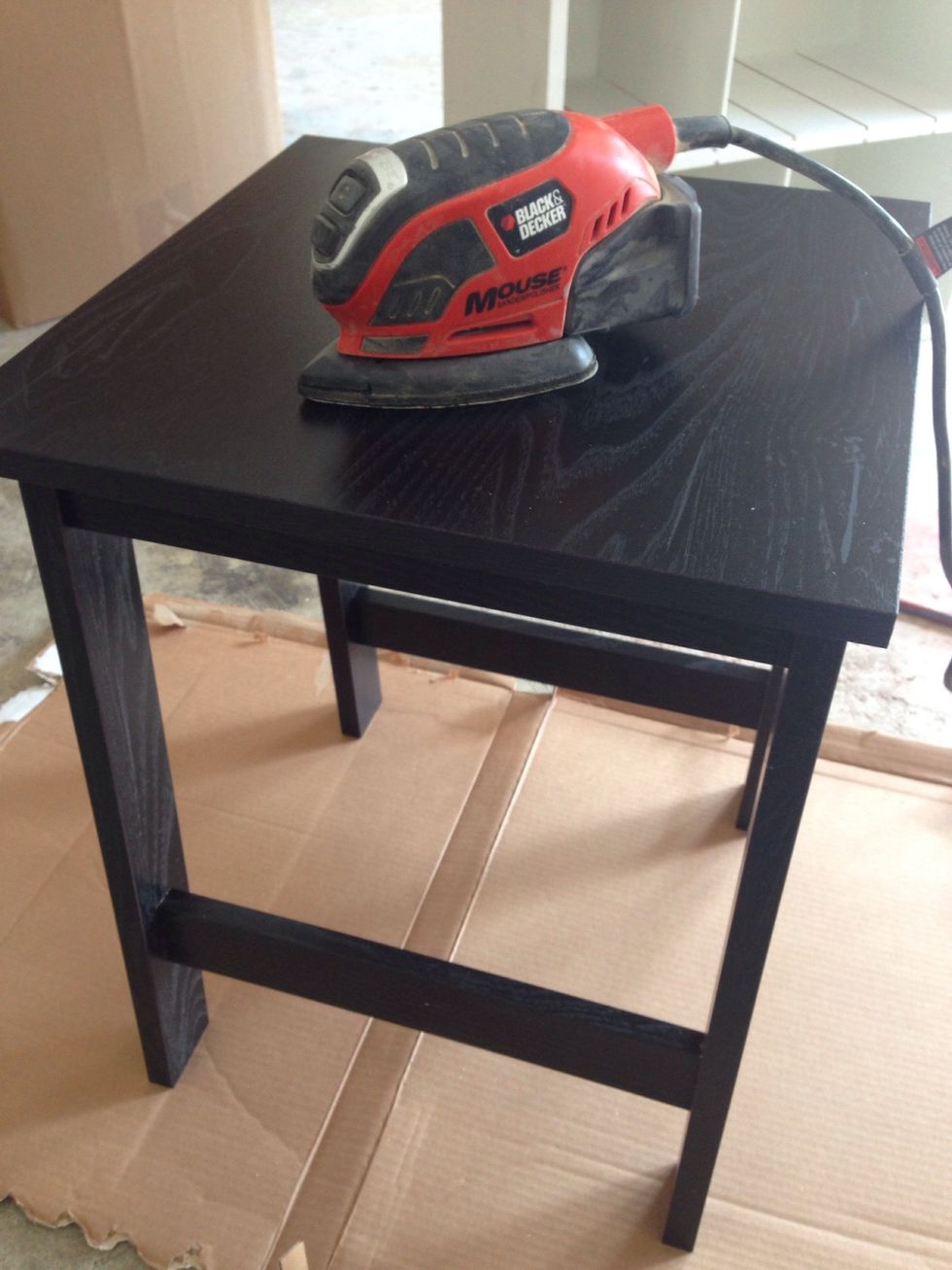 After putting the table together, I took it outside and used my mouse sander to lightly sand off the finish.