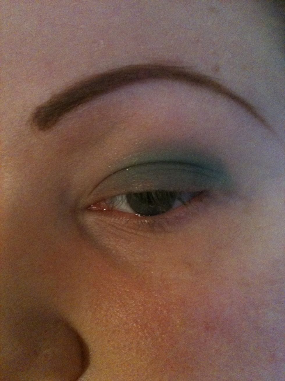 After putting your nude tone on your lid take your green and place it about 2 thirds from the outer lid to the inner lid leaving some of the nude tone showing in the inner corner.