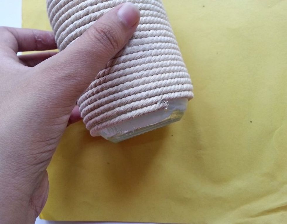 After reaching the bottom, apply some extra glue at that end and cut off extra twine.