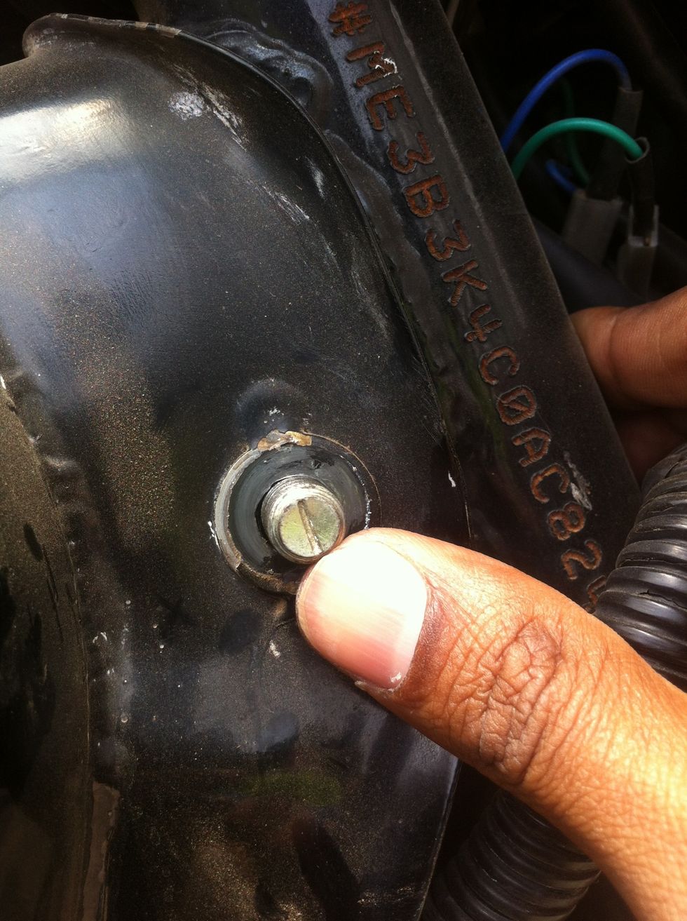 After removing the nut. Push the bolt carefully without scratching or damaging the bolt threads by slightly lifting up or pushing down the tank.