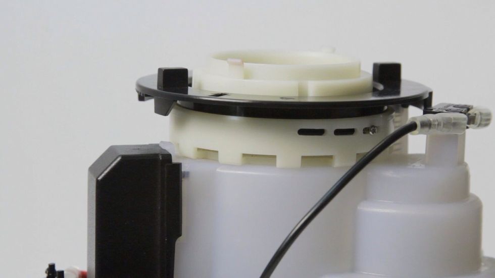 After replacing the screw, turn the black ring fully counter-clockwise. This makes it easier to line up the bean hopper later.