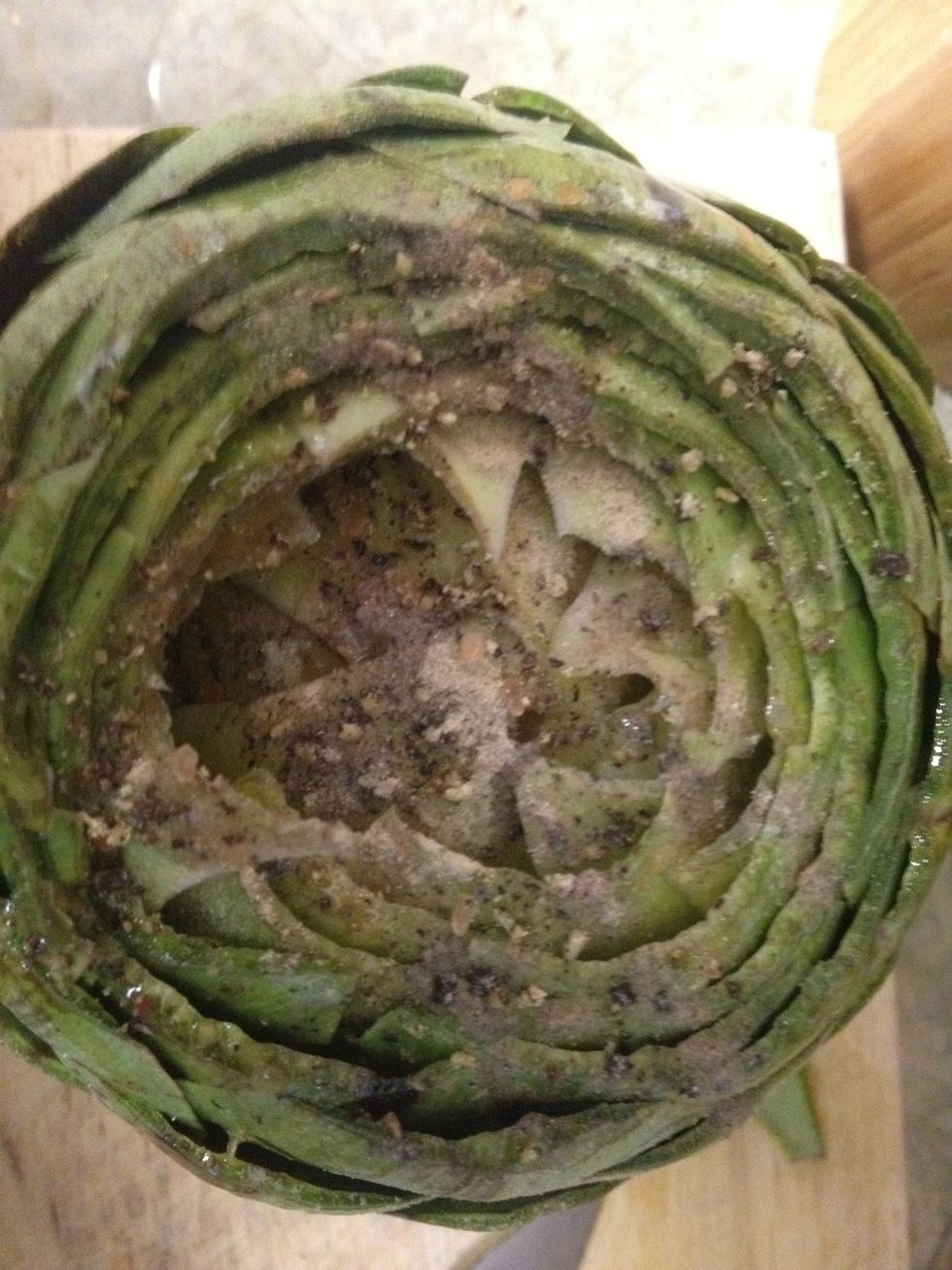 after rinsing and spreading the leaves apart, we pour olive oil and spices (we used salt, black and white peppercorn,) over the top and down the leaves.