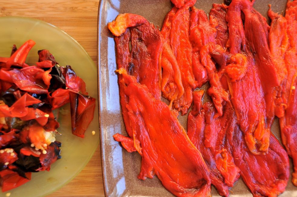 After roasting, place peppers in a bag and let them sit for about 15 minutes. It helps loosen the skin so you can peel it off. Peel them under the faucet to easily wash away the seeds.